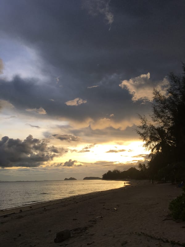 Storm clouds roll in over Ban Tai's coastline at dusk