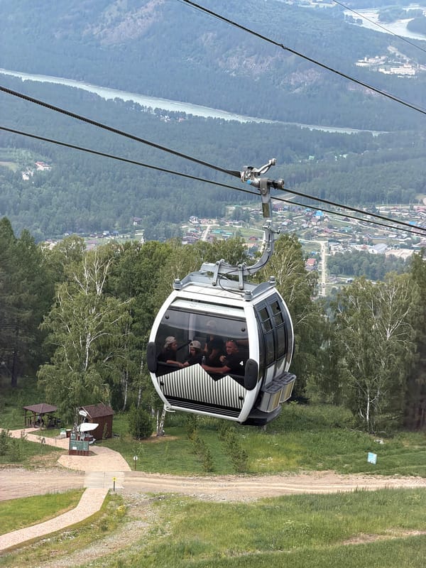 Gondola ride over green mountain valley in Ozernoe, Russia
