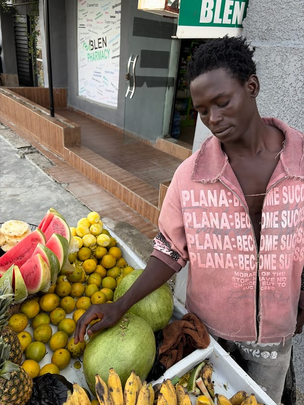 Man in motivational jacket spotted at Nigerian fruit stand