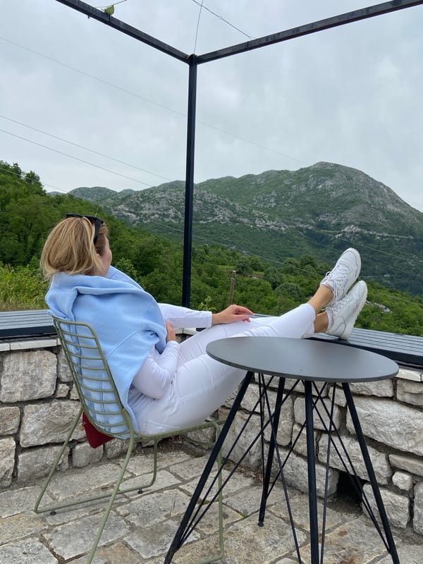 Tourist explores Montenegro mountain village via trolley and cafes