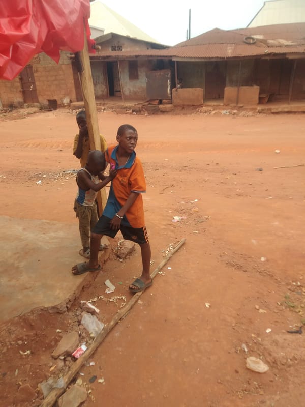 Children and adult spotted on dirt road in Ejule