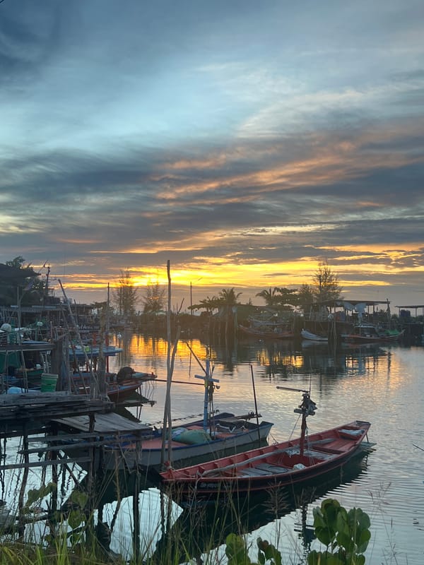Quiet fishing harbor at golden hour, boats at rest