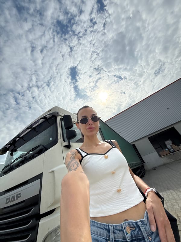 Woman poses beside white truck in Pleven, Bulgaria