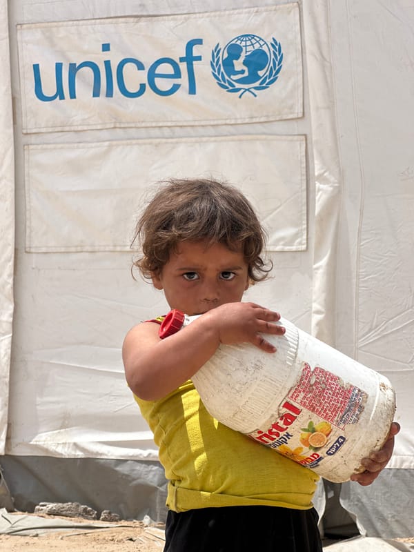 Child with juice container observed near UNICEF tent in Gaza