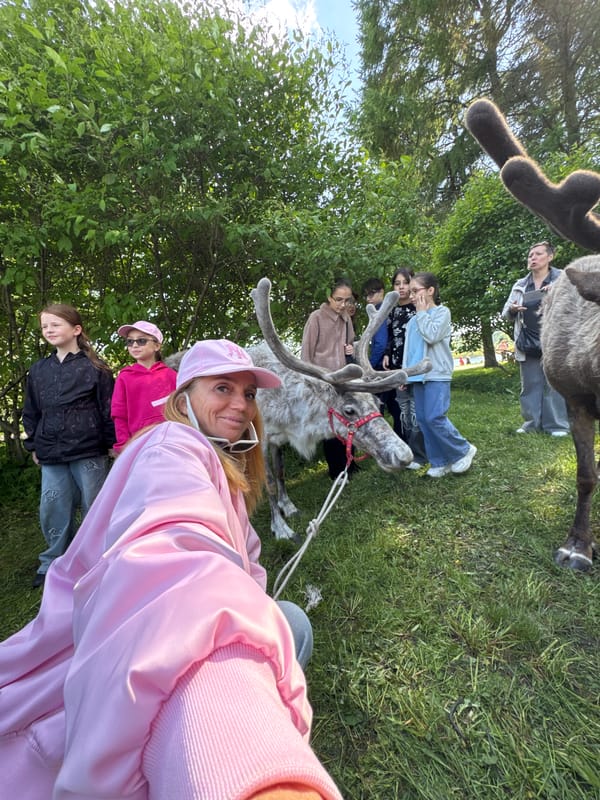 Families interact with harnessed reindeer in Russian towns