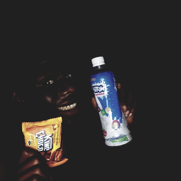 Person photographed with snacks in darkness, Narayi Nigeria