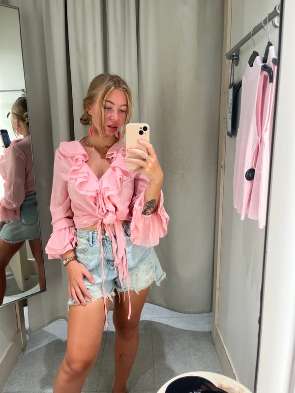Woman takes selfie in retail changing room in Thailand
