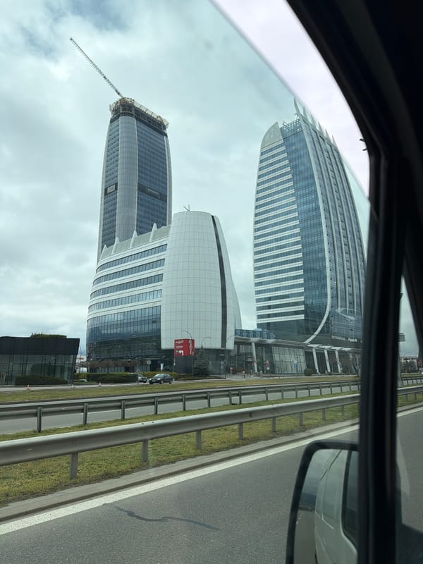 Vehicle passenger views Sofia Airport Center buildings from road