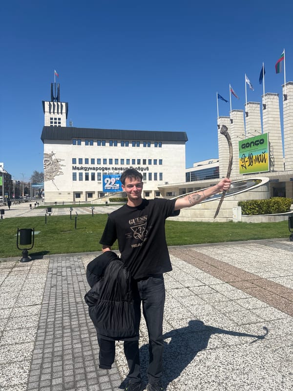 Man holds branch outside Plovdiv International Fair building
