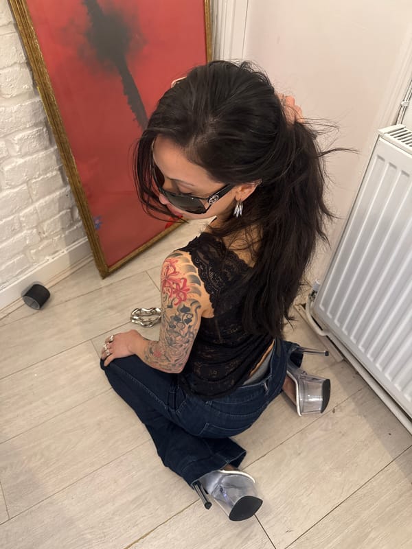 Woman with floral tattoo rests on floor in London