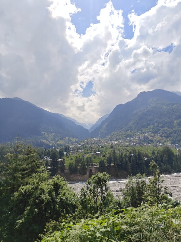 Tourist captures panoramic valley views in Manali, India