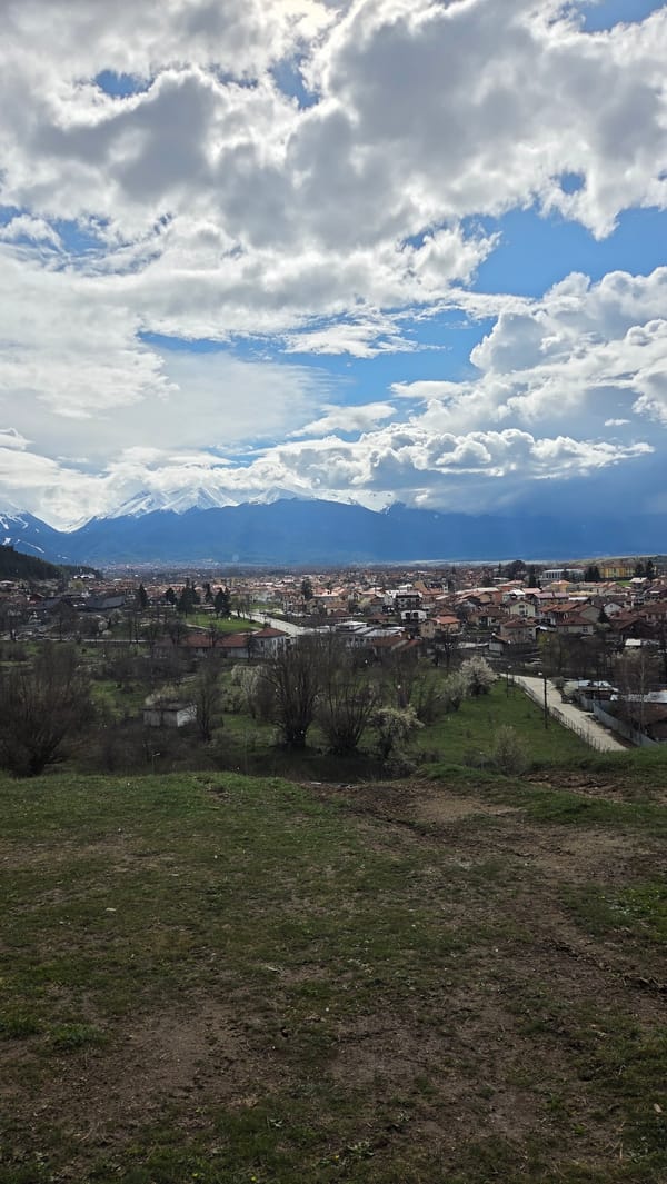 Panoramic view captured of Bulgarian town beneath snow-capped mountains