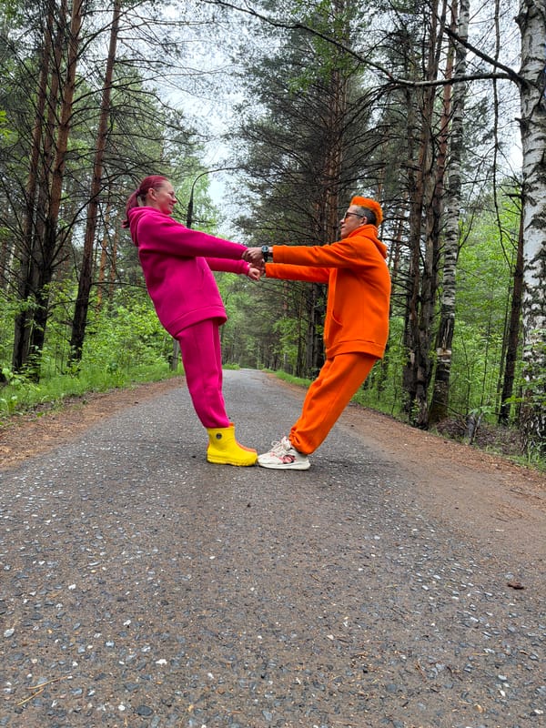 Couple in bright tracksuits share playful moments in Russian park