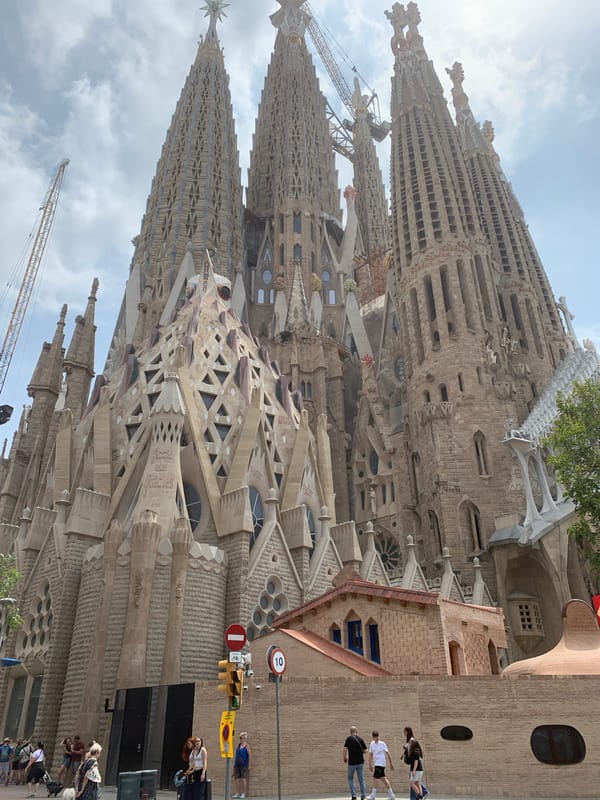 Skateboarder visits Barcelona's Sagrada Familia on sunny Tuesday morning
