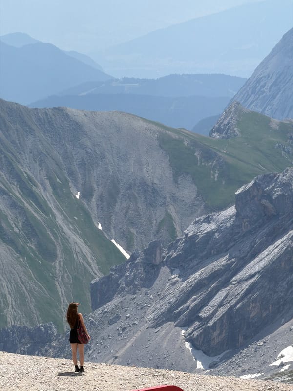 Overlooking a vast alpine panorama from a rocky Garmisch ledge