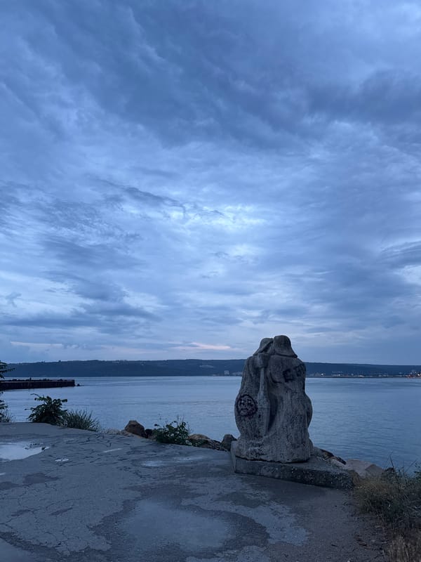 Abstract stone sculpture at Varna's Black Sea waterfront, dusk