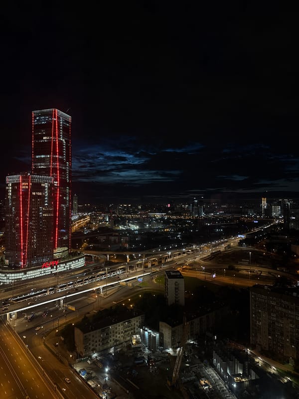 Khimki at night: IG City tower and lit-up highway sprawl