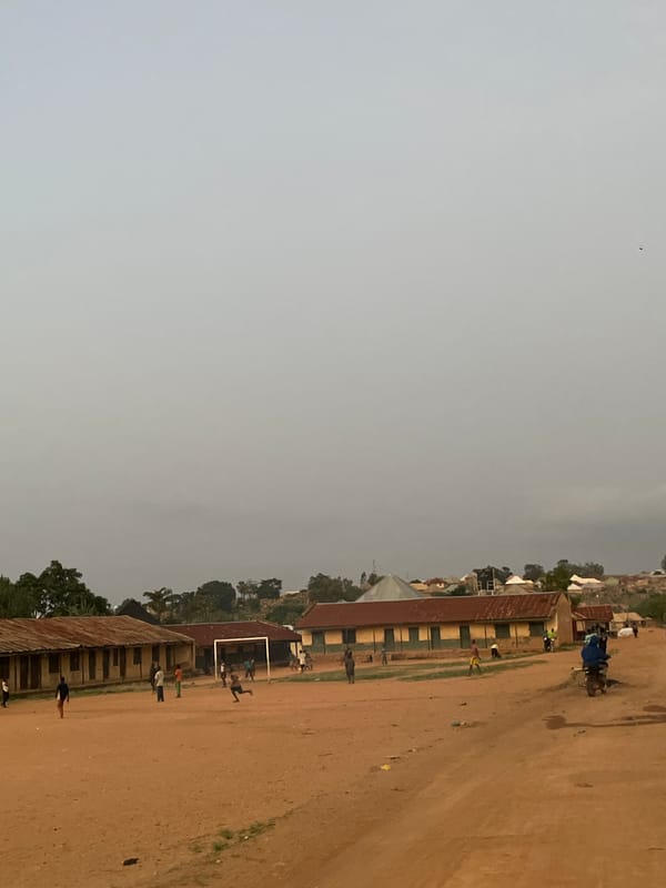 Children play soccer, walk barefoot in rural Nigerian village