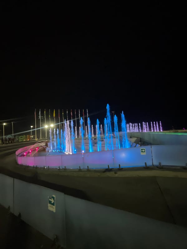 Illuminated fountain operates at night in Iquique pedestrian area