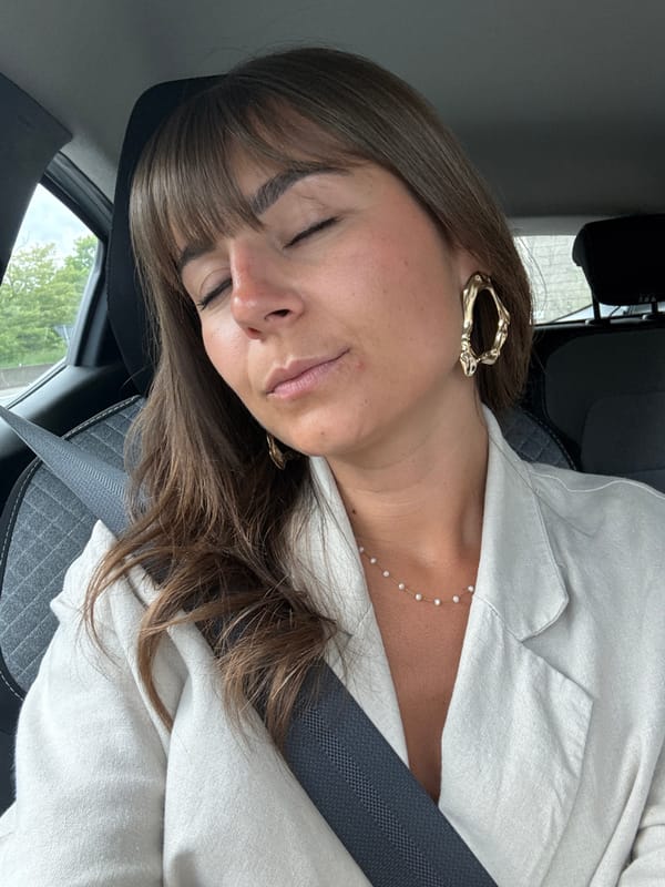 Woman rests in moving car in Saint-Étienne