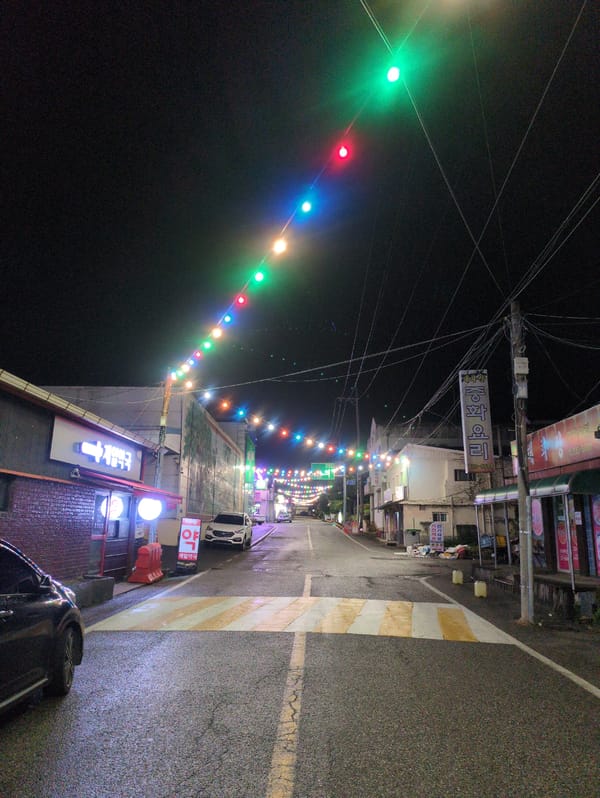 Nighttime street photography documents illuminated Iwon, South Korea scenes