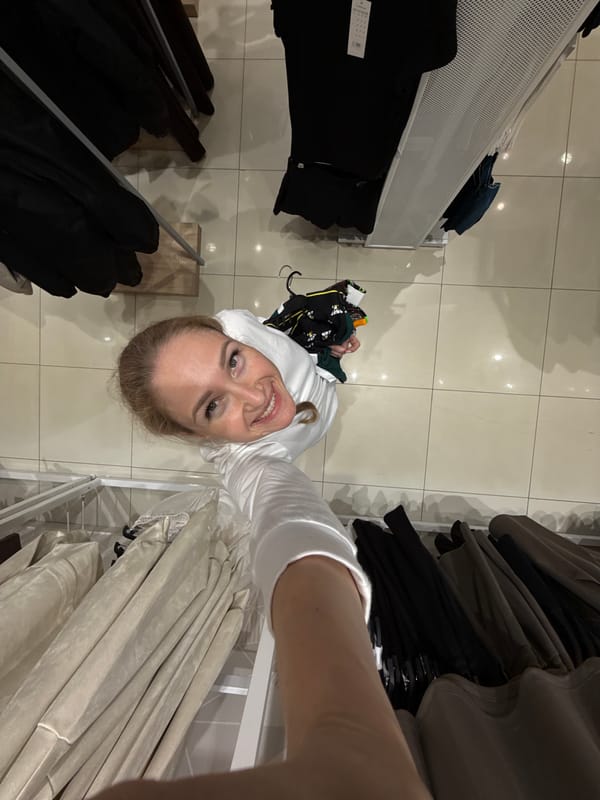 Woman takes shopping selfies in Chaikovsky clothing store