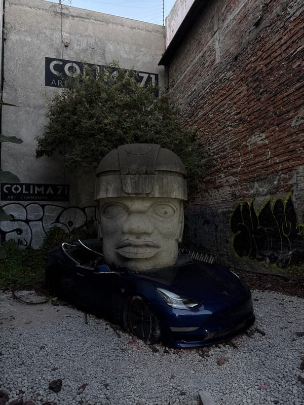 Blue Tesla meets ancient Olmec sculpture in Mexico City street art scene