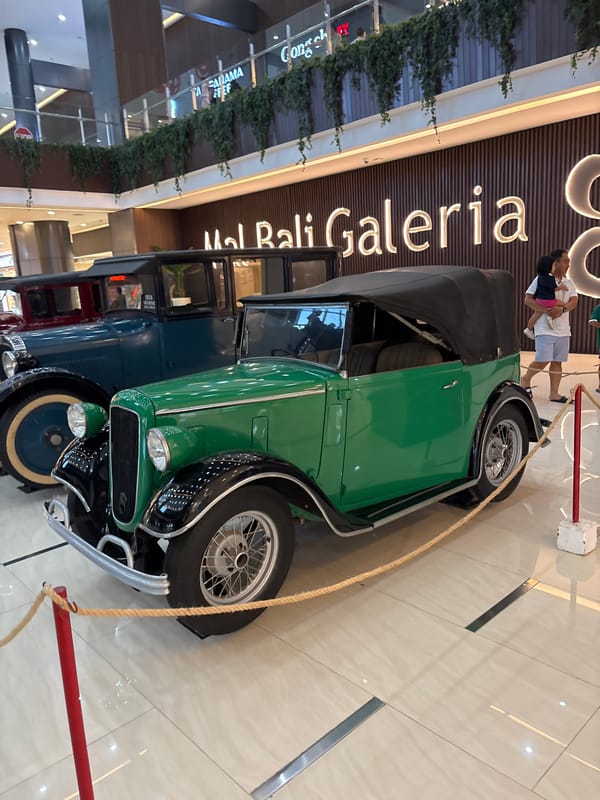 Vintage car exhibition displays classic automobiles at Kuta shopping mall