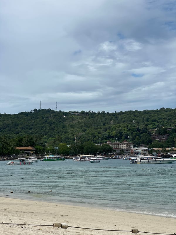 Ao Nang beach on a quiet morning, boats and limestone cliffs