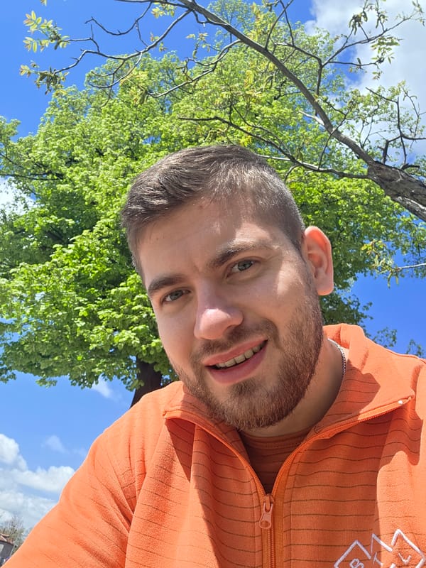 Man takes selfie near modern building in Plovdiv park