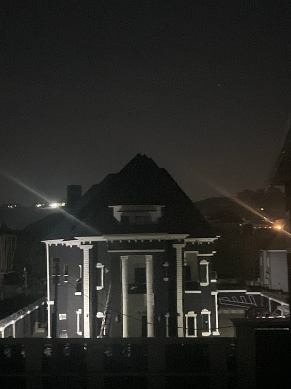 Illuminated multi-story building observed at night in Abuja