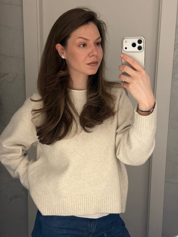 Woman takes early morning selfie in Riga wearing clover jewelry