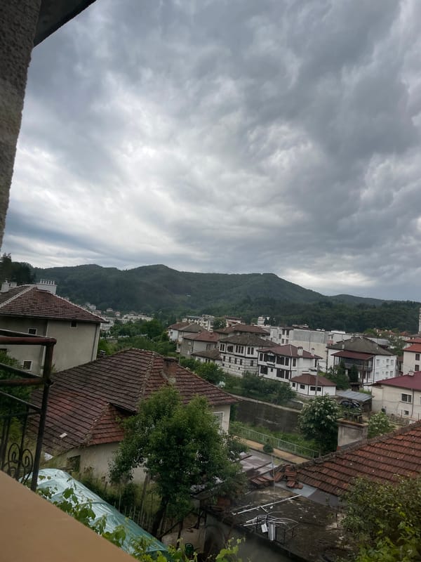 Dramatic clouds captured over Bulgarian mountain town from balcony