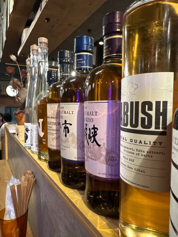 Specialty alcohol bottles with herbal extracts observed in Meguro