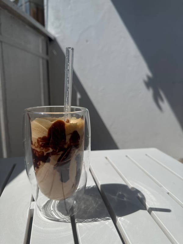 Iced coffee with chocolate syrup on an outdoor table in Varna
