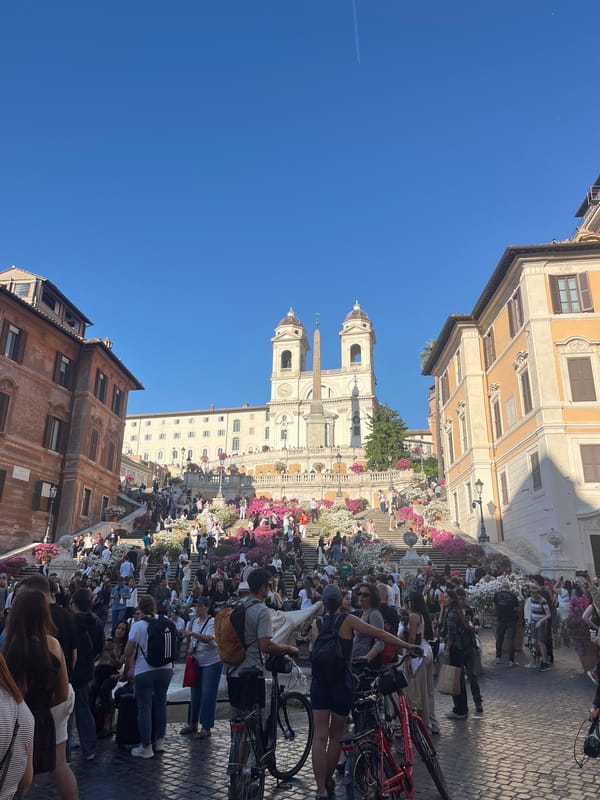 Crowds gather at Rome's Spanish Steps under clear skies