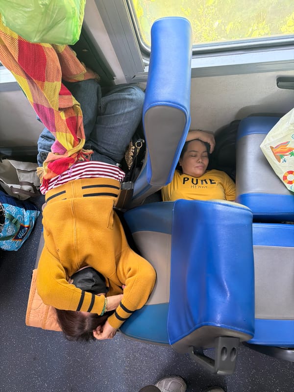 Train passengers sleep during overnight journey in Huế, Vietnam