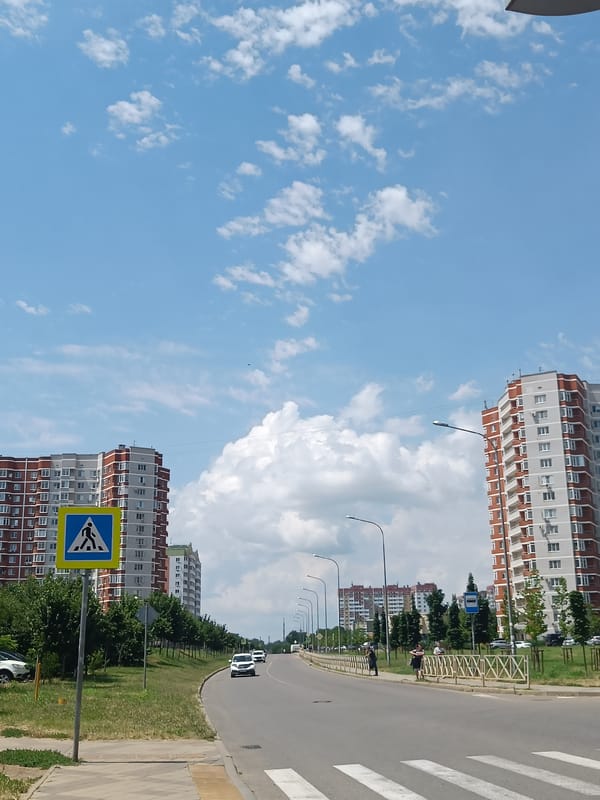 Red and white apartment block on a Krasnodar residential street