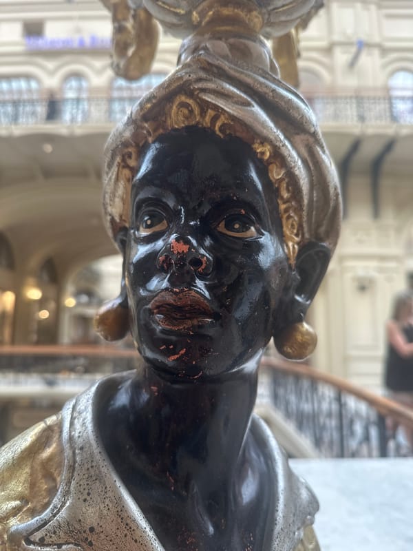 Tourist documents Red Square landmarks and bronze bear sculptures
