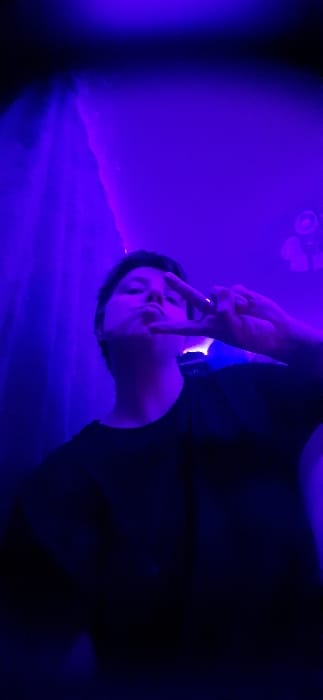 Purple-lit social gathering documented in Saratov apartment
