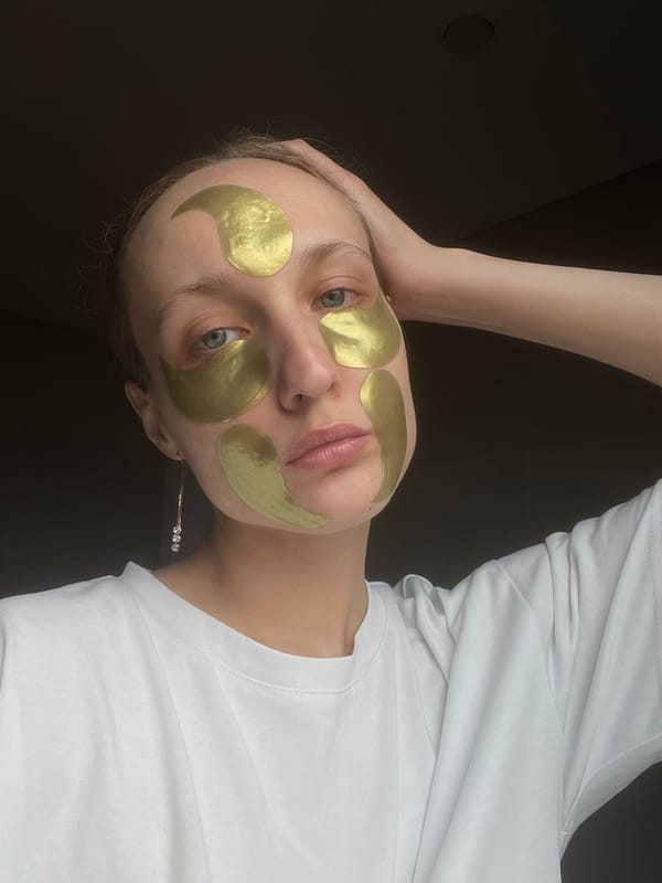 Woman takes bathroom selfies wearing gold facial patches