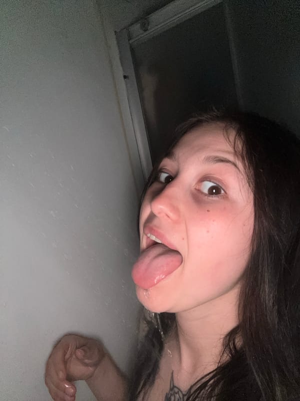Woman makes playful gesture in bathroom, Foki Russia