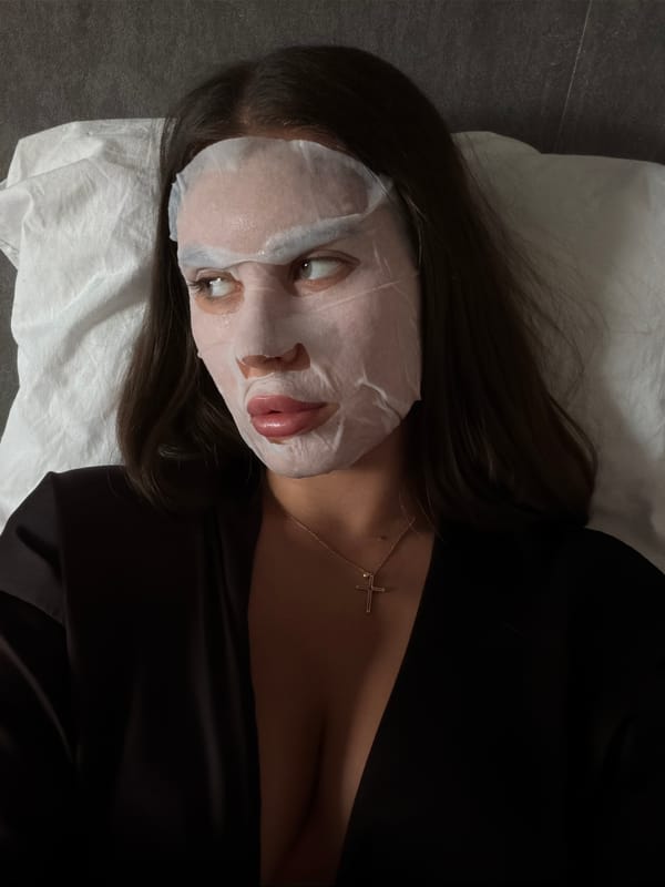 Woman applies facial mask during late-night skincare routine in Krasnoyarsk