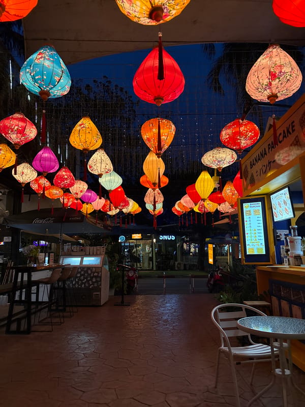 Porto de Phuket glows at dusk under hundreds of colorful lanterns