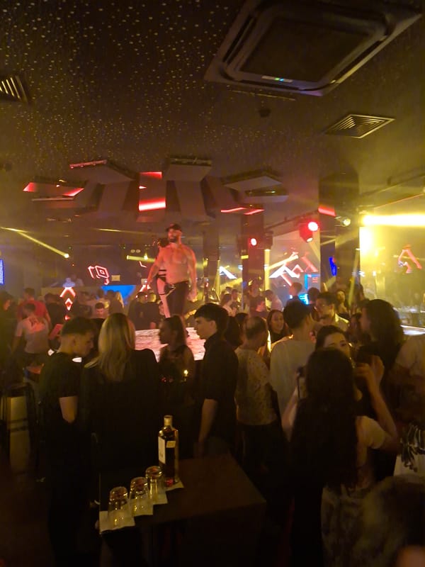 Crowded nightclub scene with shirtless man observed by witness