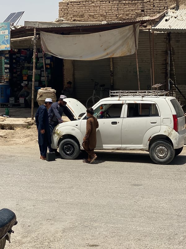 Daytime street scene documented outside Kandahar shop