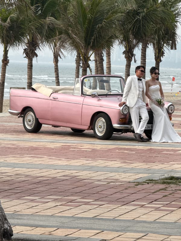 Wedding photoshoot with vintage pink car on Đà Nẵng beachfront