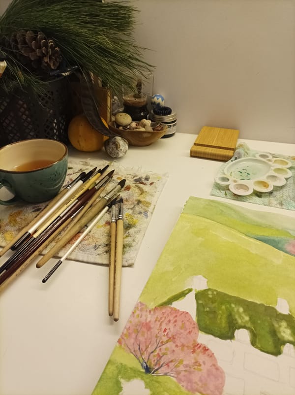 Art workspace with sketchbook and mug documented in Batumi