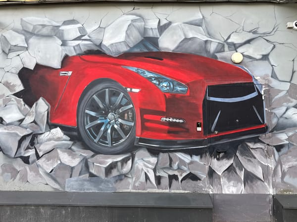Street art mural features emerging sports car in Saint Petersburg