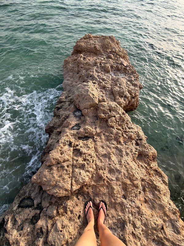 Visitor explores rocky coastline formations in Sharm El Sheikh
